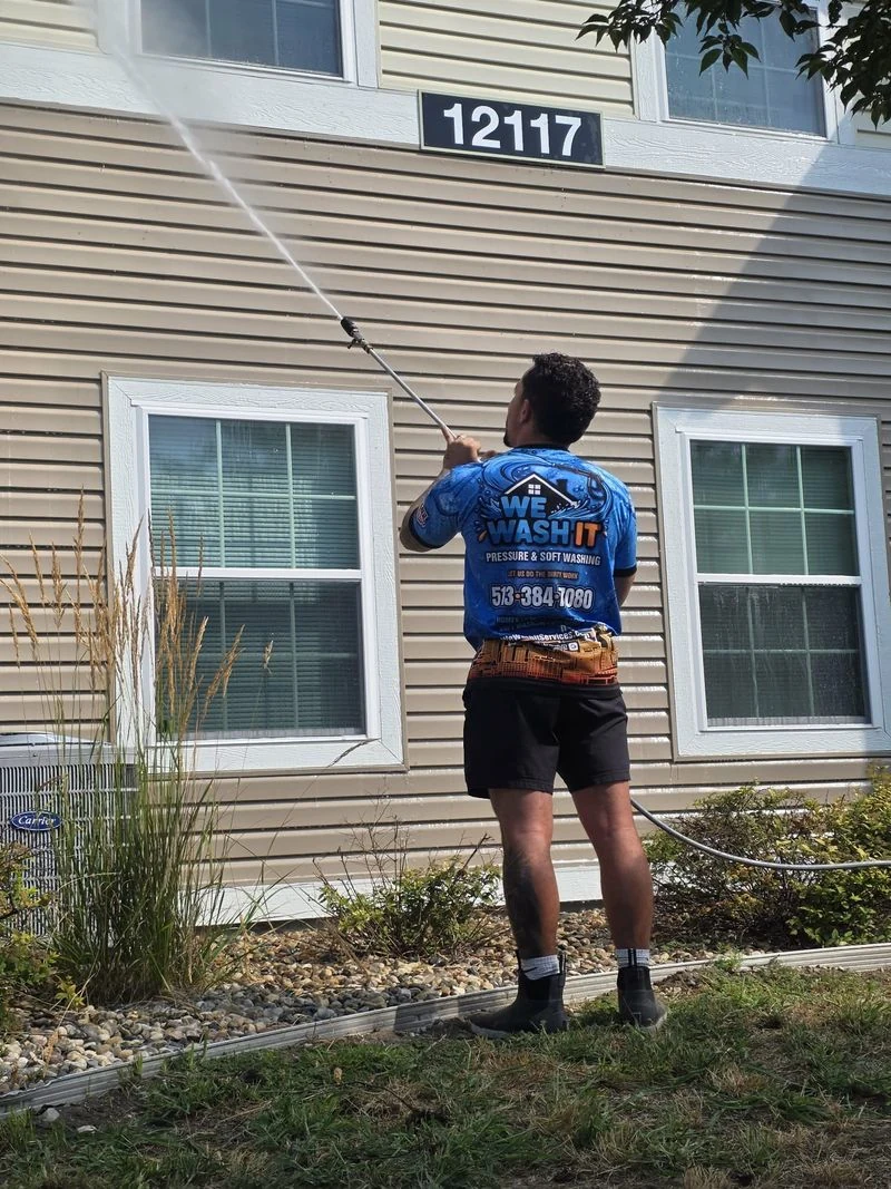 We Wash It carefully washing a home's siding