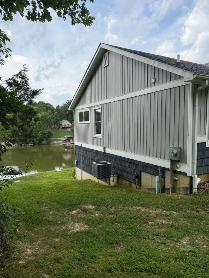 A cleaned home exterior beside a lake from the We Wash It portfolio